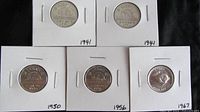 Front view of five Canadian nickels in white cardboard holders with year labels: two 1941, one 1950, one 1956, one 1967.