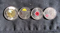 Front side of four Canadian commemorative coins showing coloured designs: 2021 Toonie, 2013 quarter, 2008 quarter, 2011 quarter.