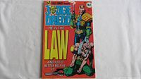 Front cover of Judge Dredd No. 1 comic book from 1983 by Eagle Comics showing Judge Dredd character and bold text 'HE IS THE LAW'.