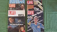 Seven Life magazines from 1973, 1976, Winter 1977, 1978, and 1987. Visible covers include Nixon on 1973 edition and The New Youth on 1978 edition.