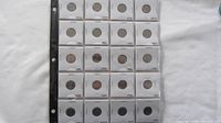 Sheet holder with Canadian dimes from 1976 to 1985. Each coin is individually placed in a white holder with the year printed above.