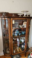 Full front view of oak china cabinet with top display of china (contents not included)