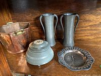 Overall group shot showing all items: two hammered metal vases, lidded trinket bowl, copper pot, and decorative pierced dish.