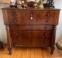 Front view of mahogany dresser showing drawers and turned pillars