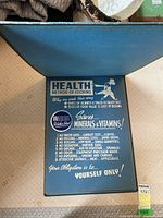 Photo of inside cover page with a blue background and health-related cooking method poster promoting mineral and vitamin savings using Aristocrat Stainless Steel.