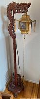 Full view of carved dragon floor lamp with shade