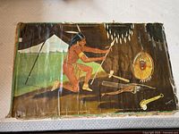 Full front view of unframed oil painting depicting kneeling Native American and ritual items