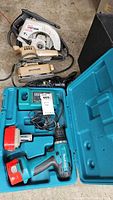Makita drill, Worksmith rotary tool, Black & Decker finishing sander and Sears Craftsman circular saw viewed together on floor.