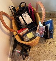 Hair styling appliances including irons, dryers, and baskets in a woven basket on a counter.