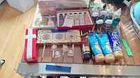 Full overview of the variety of lotions, creams, and soap on a table including boxed sets and small bottles.
