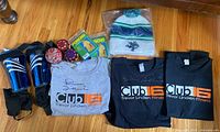 View of entire lot including signed T-shirts, shin guards, hacky sack balls, tuque and packaging