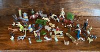 wide view of all figures and accessories on wooden surface