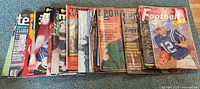 Photo showing entire lot of 13 vintage sports magazines with various colorful covers spanning tennis, hockey, football, baseball