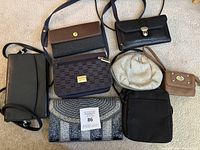 Overview photo showing all 7 women's clutches and wallets in different styles and colors on a carpeted floor.