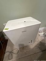 Front view of the white Danby dehumidifier showing the digital control panel on top and overall unit shape.