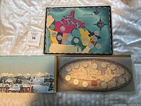 Top view showing three different Canadian coin sets in original packaging, including a Canada 125 coin set with map backer, a winter village scene backer, and an oval backer set.