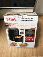 Front of boxed T-fal Easy Fry XL digital air fryer with product image and key features on the packaging.