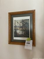 Framed art print titled Northern River, numbered 1288/1750 by Tom Thomson, showing the full view of the framed piece on a white wall.