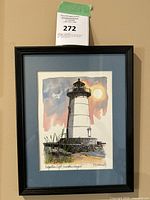 Framed watercolor print showing full artwork of Edgartown Light in black frame with label overhead.