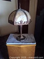 Full view of lamp on pedestal showing base and shade