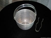 Top view of aluminium ice bucket and tongs
