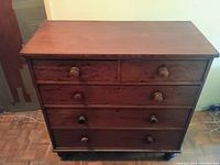 Front and top view of mahogany dresser showing five drawers