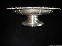 Side profile showing pedestal base and fluted bowl