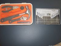 Both tool cases closed, showing orange-lined hand tool kit and clear precision screwdriver set