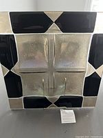 Top view of the square artistic glass platter showing its black and frosted geometric design divided into four sections.
