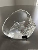 Front view of the clear lead crystal sculpture showing the detailed bird inside and textured facets.