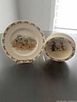 Photo showing both the ceramic dinner plate and bowl, each with rabbit-themed illustrations and borders