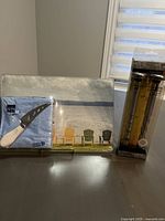 Close view of cheese board pack, cutter, and napkins.