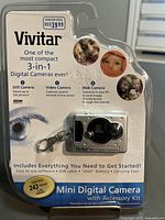 Front packaging of Vivitar Mini Digital Camera showing 3-in-1 functionality (still, video, web camera), storage capacity of 243 photos, and included accessories.