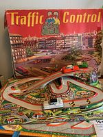 Full view of the vintage metal traffic control track with box in background showing city street scene and title 'Traffic Control'. Shows road layout with ramp and cars positioned on track.