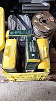 Yellow crate containing inverter boxes and wire spools