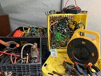 Three crates filled with various ropes, clamps, and pulleys.