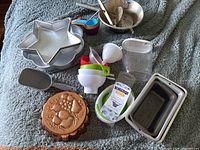 Photo showing all items spread out including pans, measuring cups, food mill, funnels, and copper mold