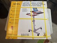 Sealed Astral Laptop Mobile Stand packaging showing product usage and features.