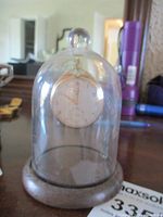 Photo of antique Elgin 10K gold filled pocket watch displayed under a glass dome on wooden base.
