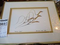 Full view of the framed print showing the artwork of birds in flight and the artist's signature.