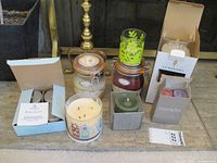 Photo of entire candle lot showing all items including candle tins, jar candles, tea lights, and candle holder.
