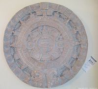 Front view of large embossed ceramic wall charger showing entire circular design with Aztec-style engraving