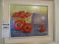 Framed oil painting showing tomatoes in a basket and scattered on a surface, with identification label tag for listing.