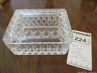 Top view of a clear crystal rectangular covered box with diamond cut pattern, showing seller's lot tag next to it.