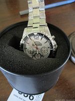 Willowlee men's wristwatch in black round container with foam padding, stainless steel band visible.