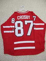 Back view of red Team Canada hockey jersey showing 'CROSBY' and number '87'.