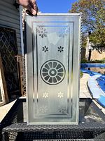 Front view of etched glass panel showing full floral and geometric pattern with attached hanging chain.