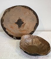 Ceramic serving plate and bowl together showing matching earthy glaze and textures