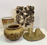Group photo showing all 4 pottery items: cylindrical vase, round bowl, sculptural plaque with birds, and abstract form piece.