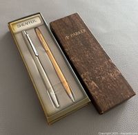 Three pens in original boxes, showing Parker, Sheaffer and Cross pen brands